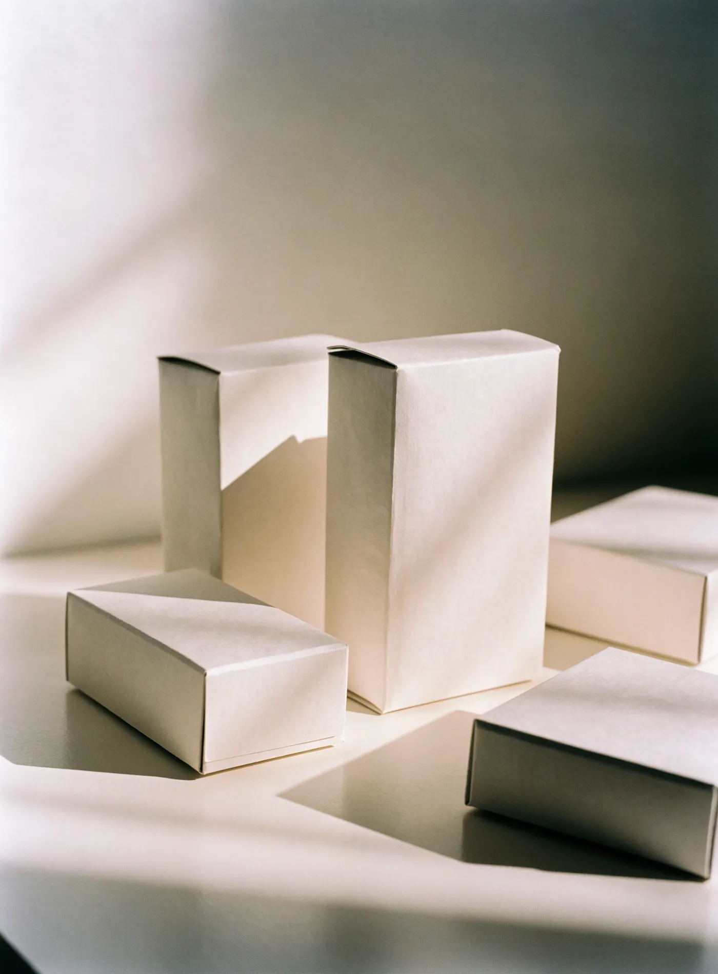 Matte paper packaging against a warm off-white ground.