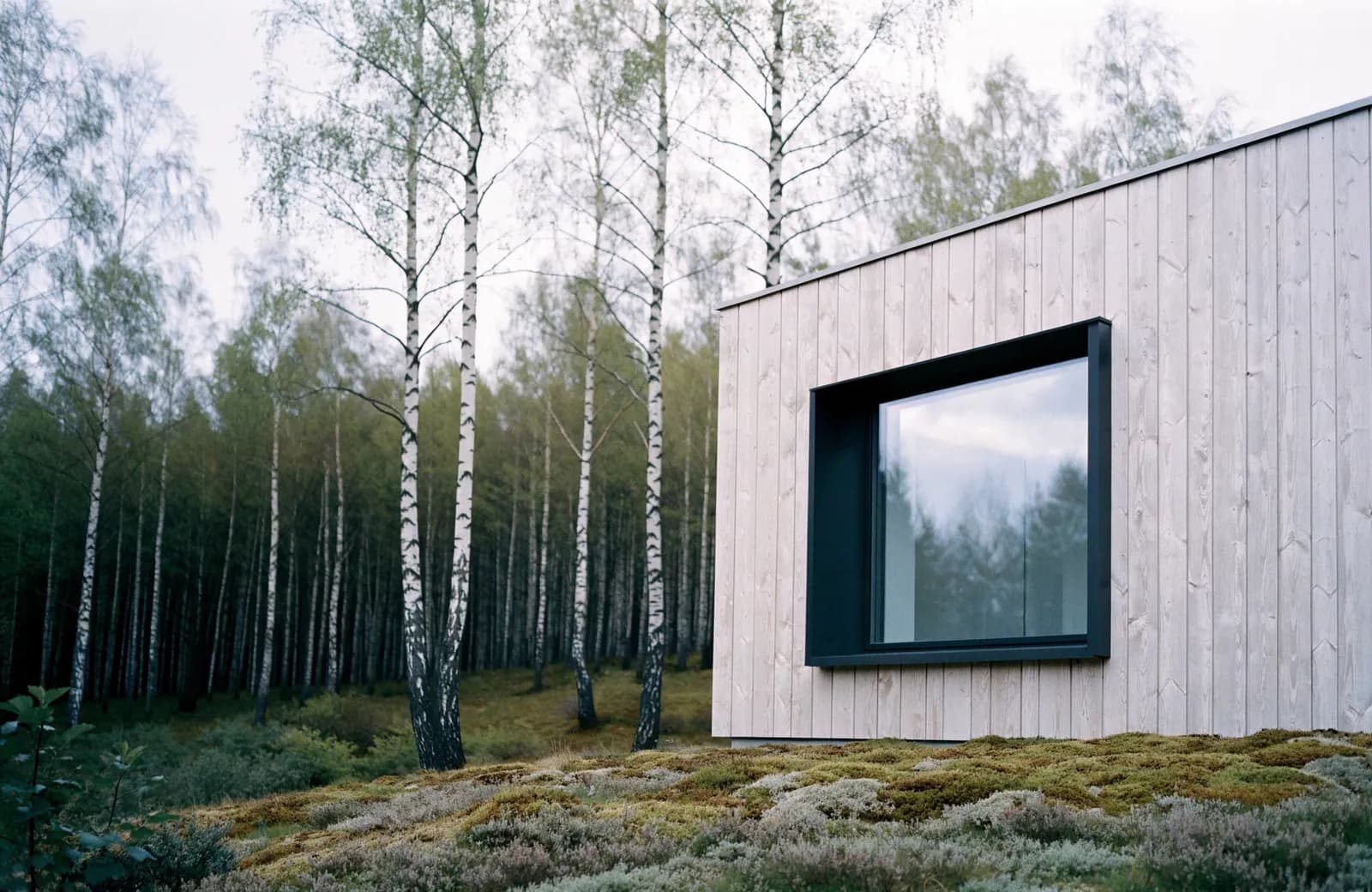 Concrete façade with a hard shadow in Nordic daylight.