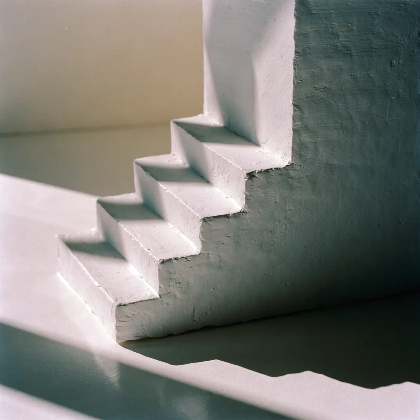 Plaster model of a building detail in raking light.